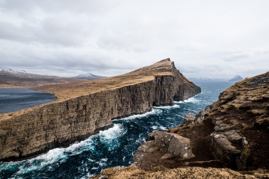 Leitisvatn above the rough ocean in Miðvágur (Faroe Islands)